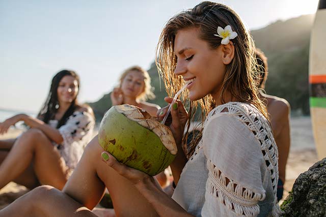 attractive woman drinking coconut water