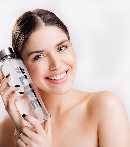 positive woman with healthy skin because she drink ionized water