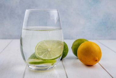 water in a glass with lime and lemon
