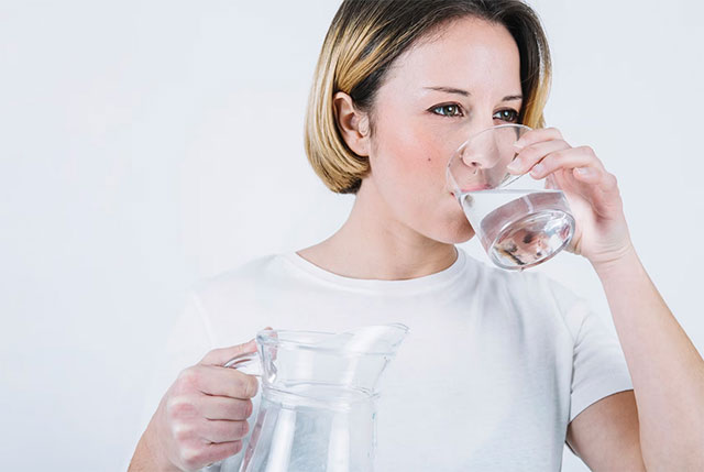 woman drinking an alkaline water a day
